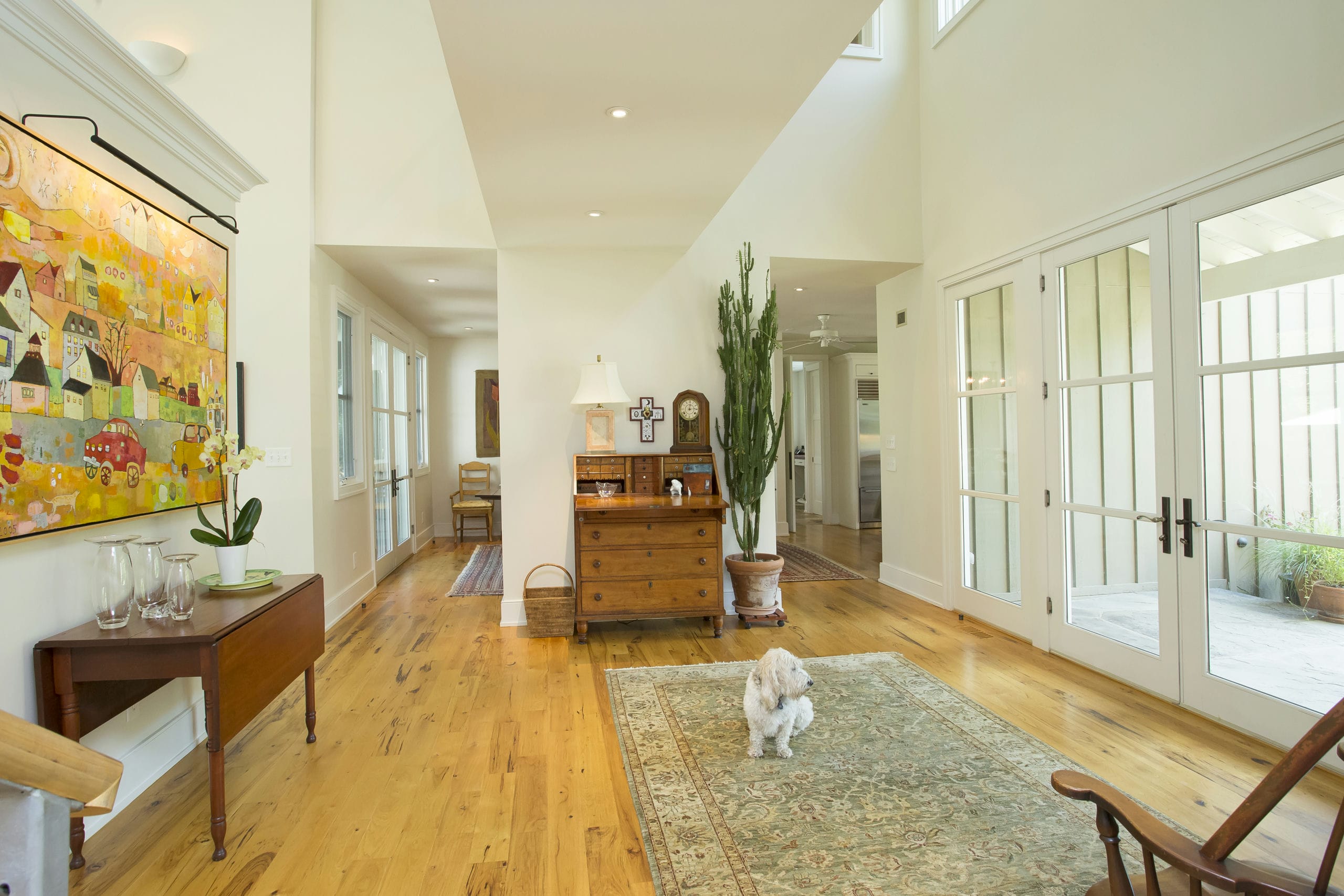 Bright and airy foyer with rustic wood floors and double height ceiling