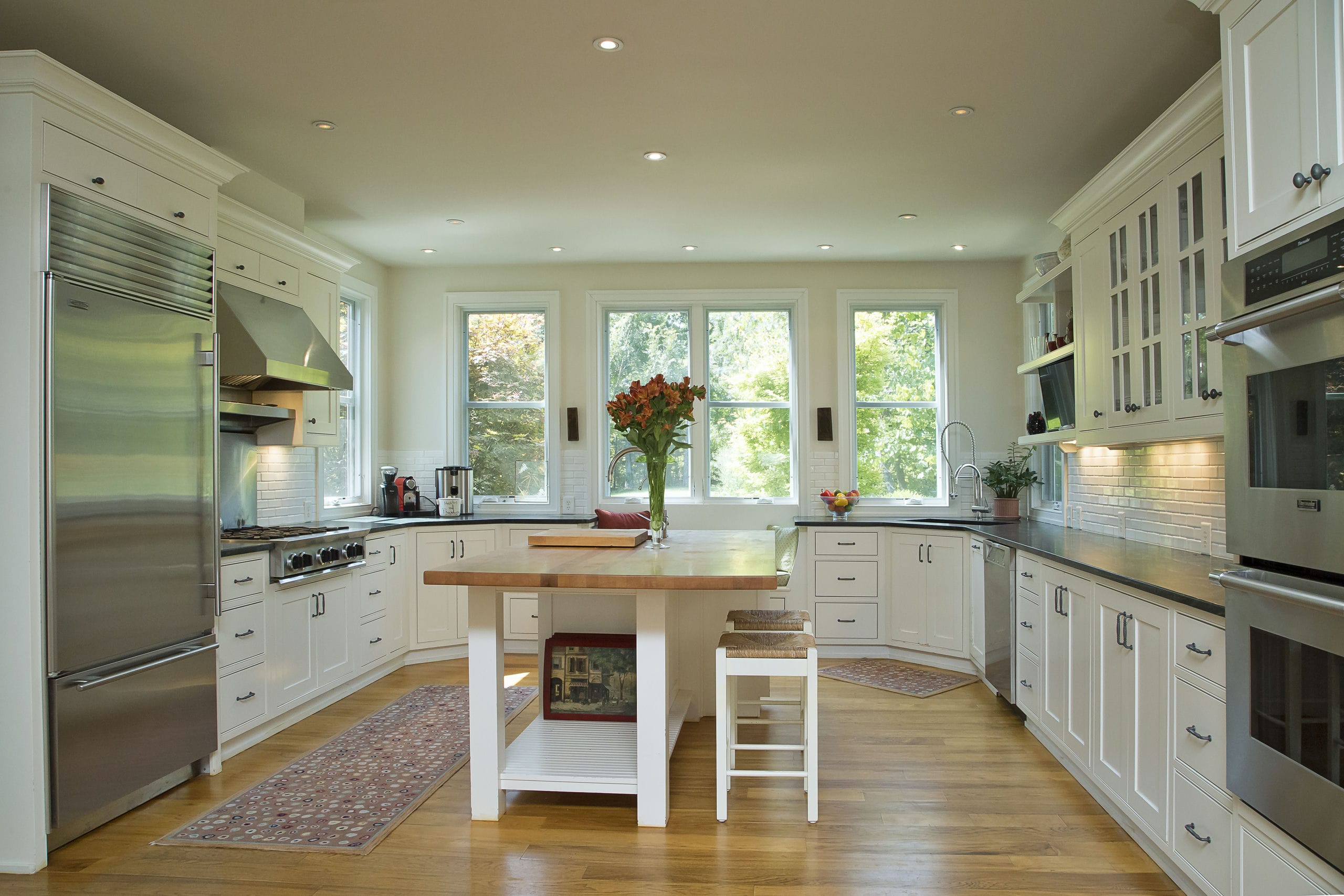 Luxury kitchen with inset cabinets and large butcher block island