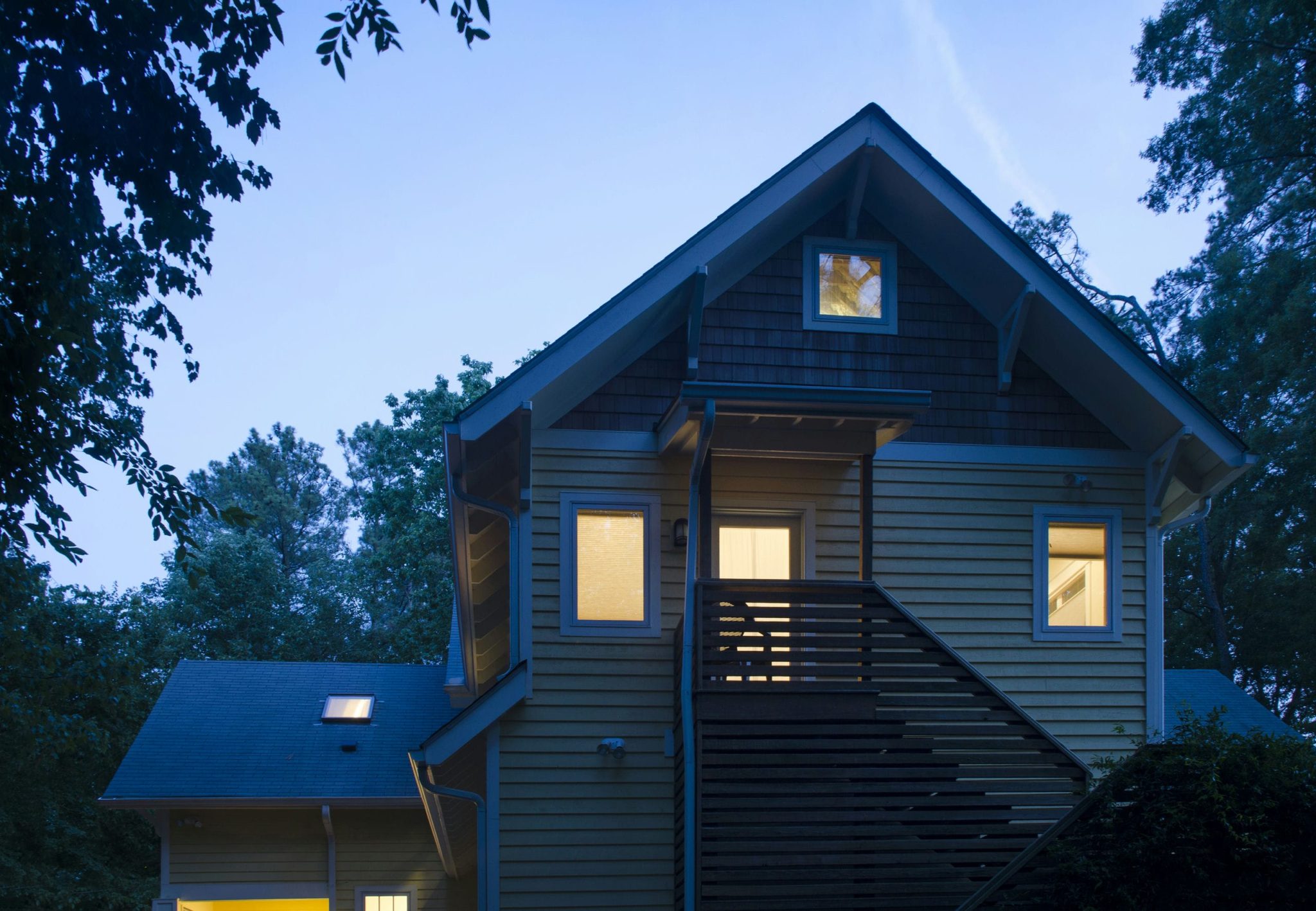 Gabled house with exposed rafter tails and cedar shake siding