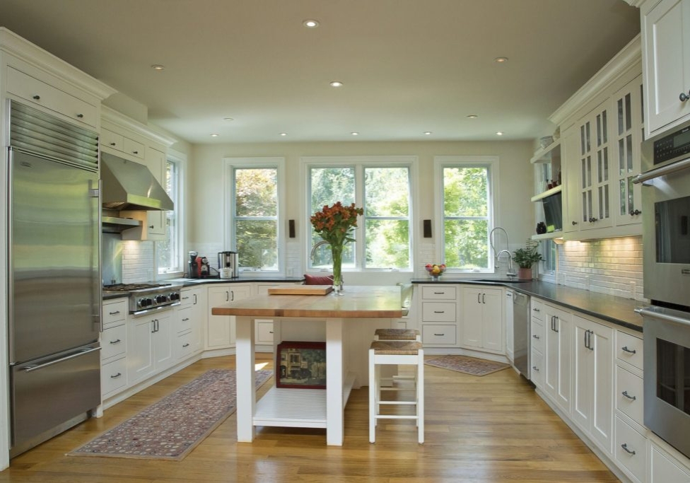 Luxury kitchen with inset cabinets and large butcher block island