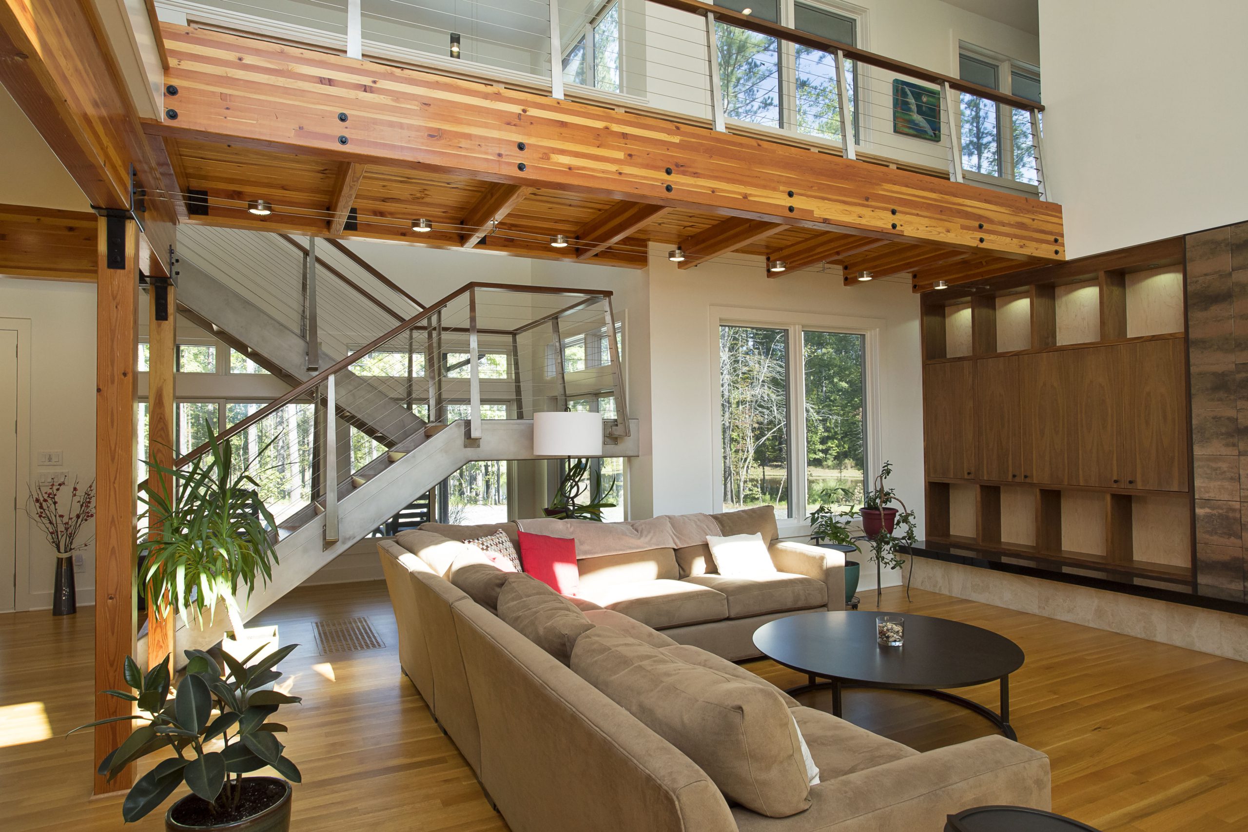 Glulam catwalk and steel staircase with cable railing in living room