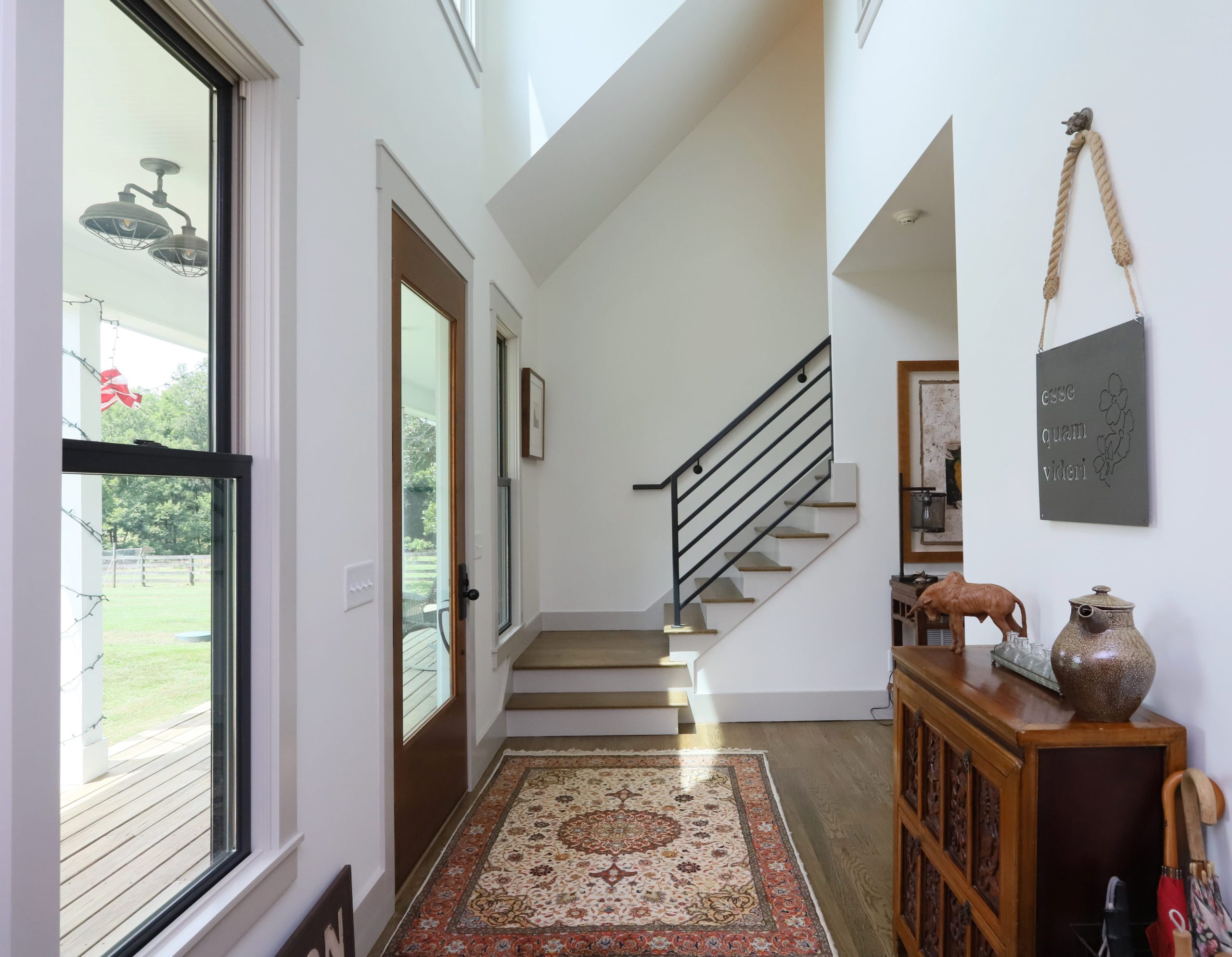 A bright and spacious foyer welcomes natural light and views of the outdoors into the home.