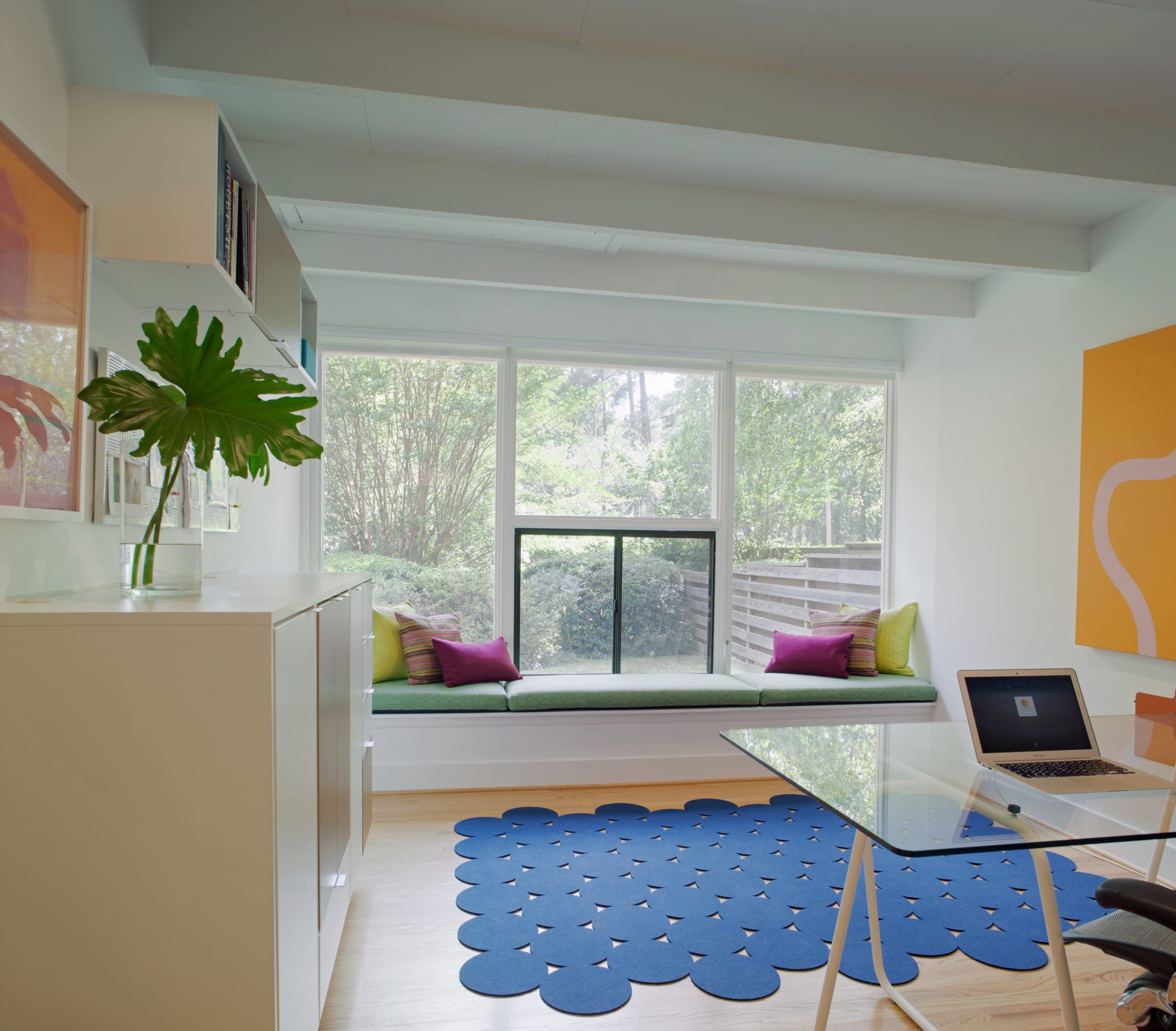 Colorful and bright office space with built-in window seat
