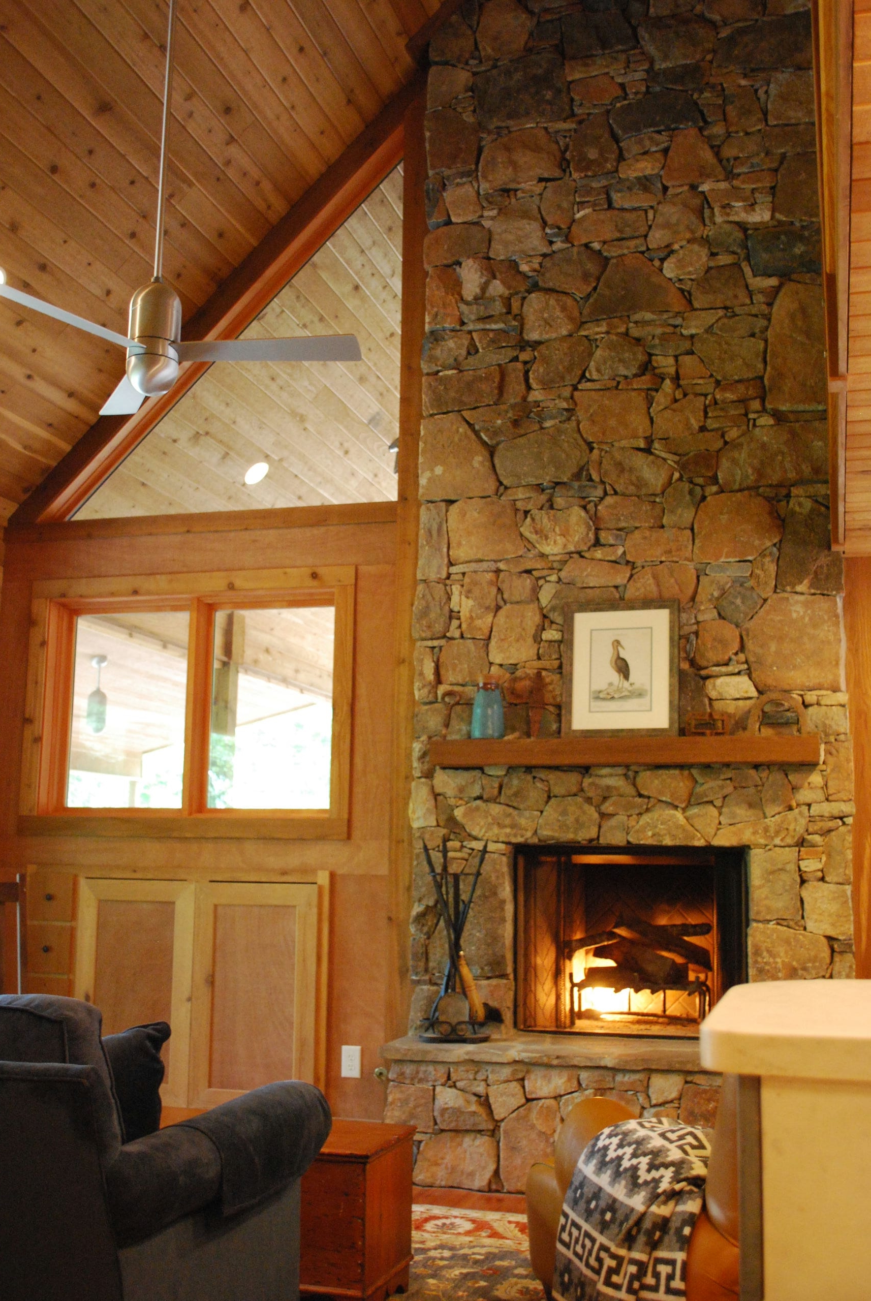 Warm interior space with vaulted wood ceilings and stone fireplace